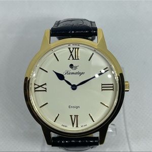 Two gold dress watches. One white dial and one black dial.